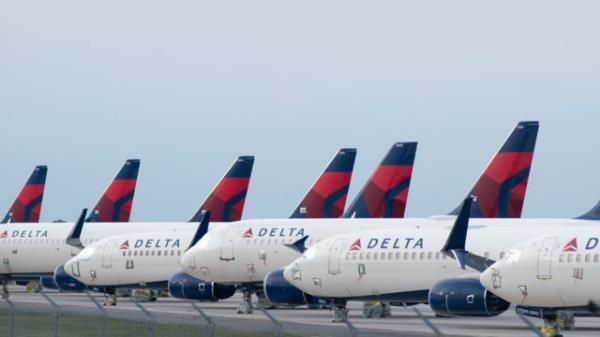 Delta Airplanes sit in a row at Kansas City Internatio<em></em>nal Airport